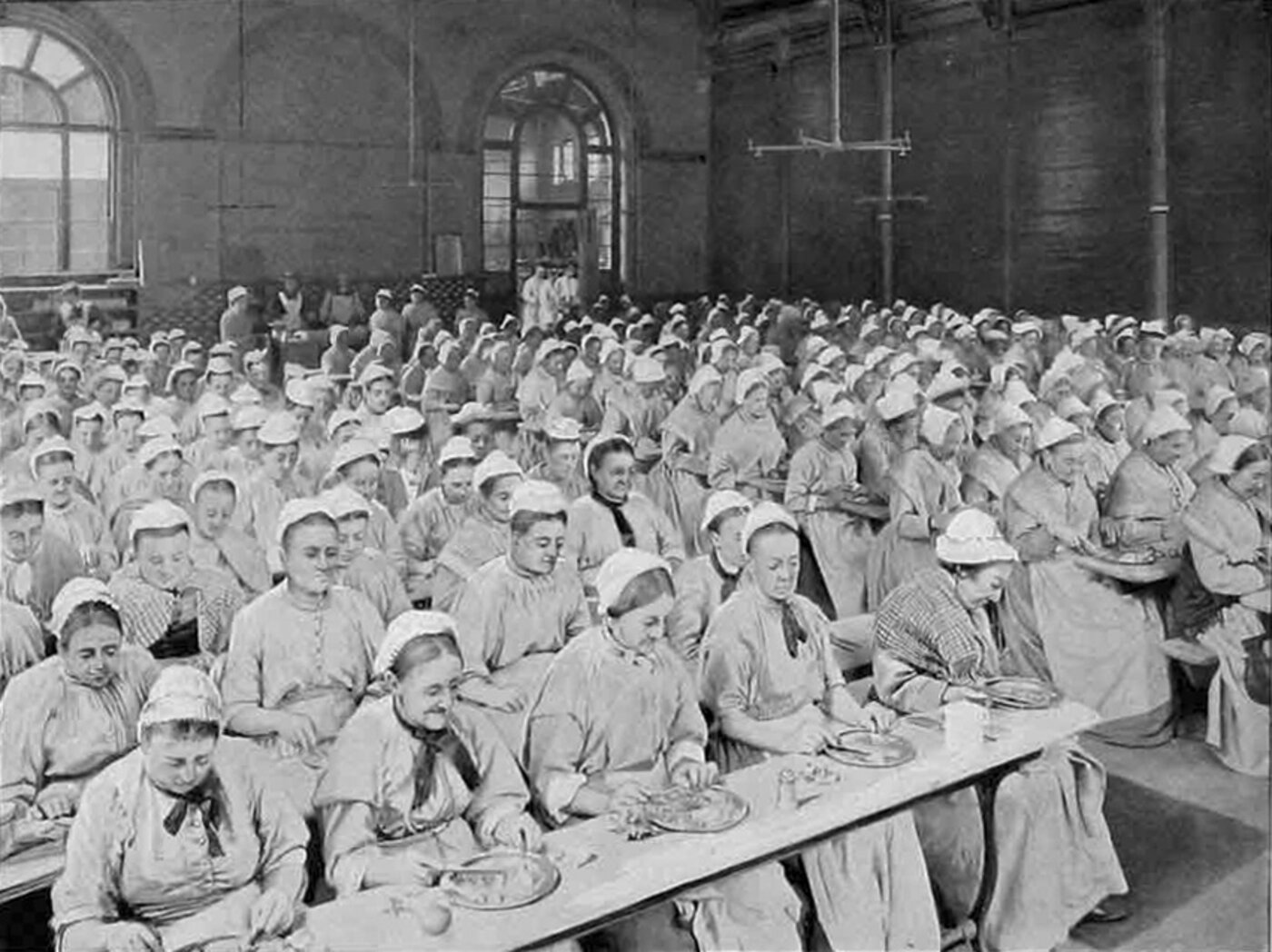 A photograph shows rows of women seated at tables eating.