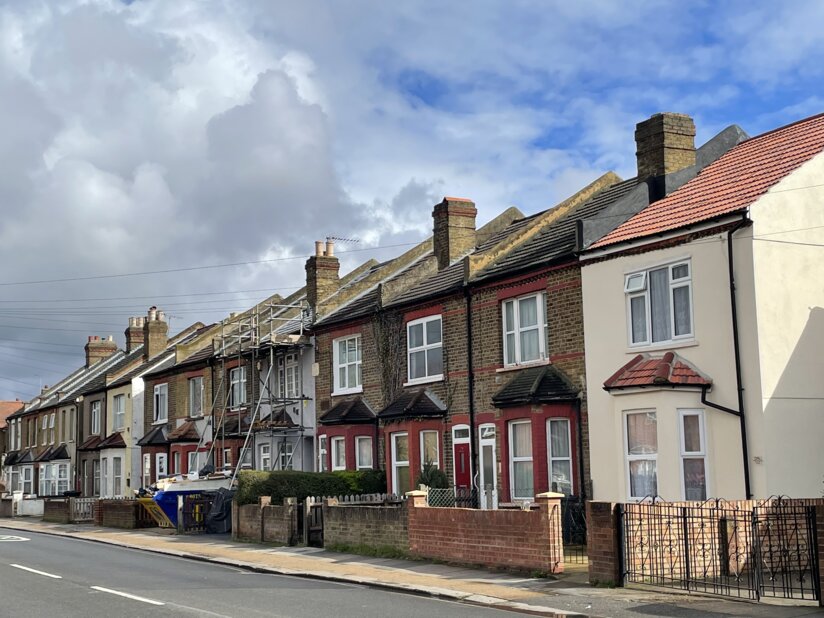 City street with set of two-story row houses.