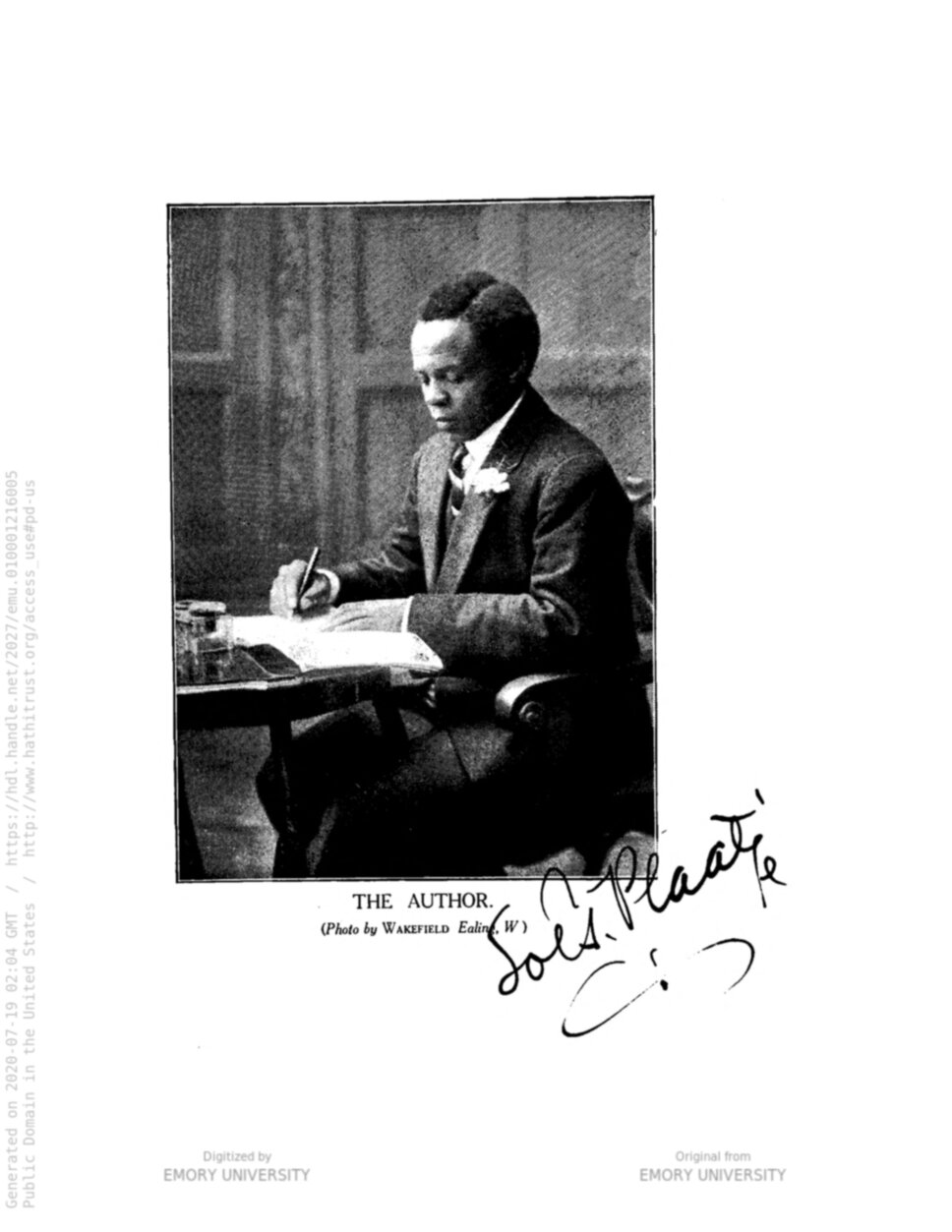 Half-body portrait of Solomon T. Plaatje, seated, in three-quarters profile, writing at a table.