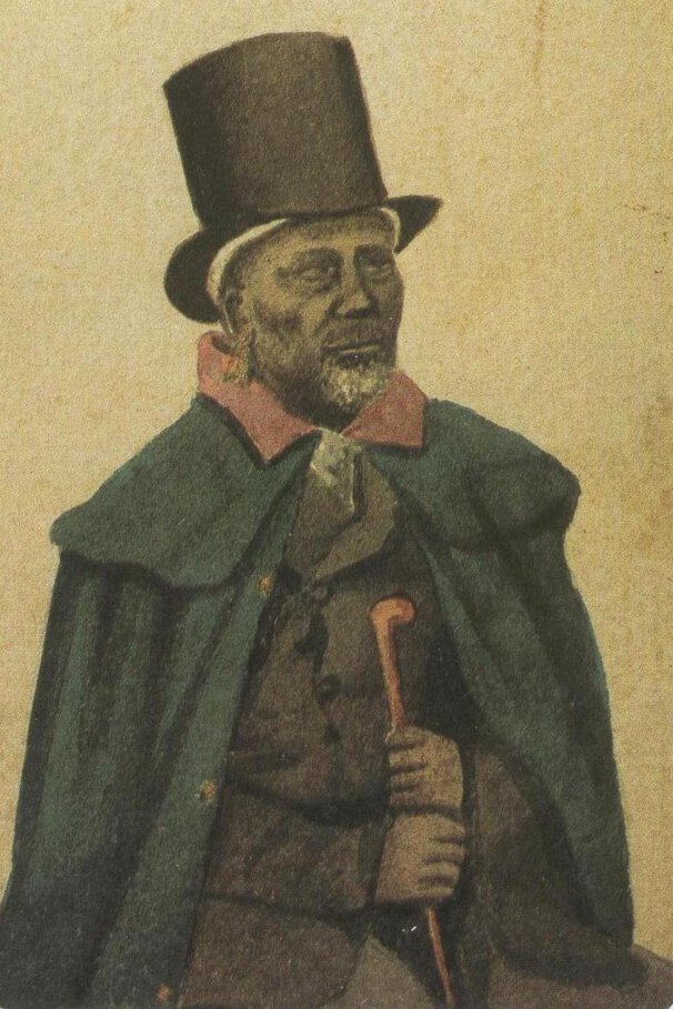 Moshoeshoe I seated, holding a cane, and dressed in formal attire including a top hat and overcoat.