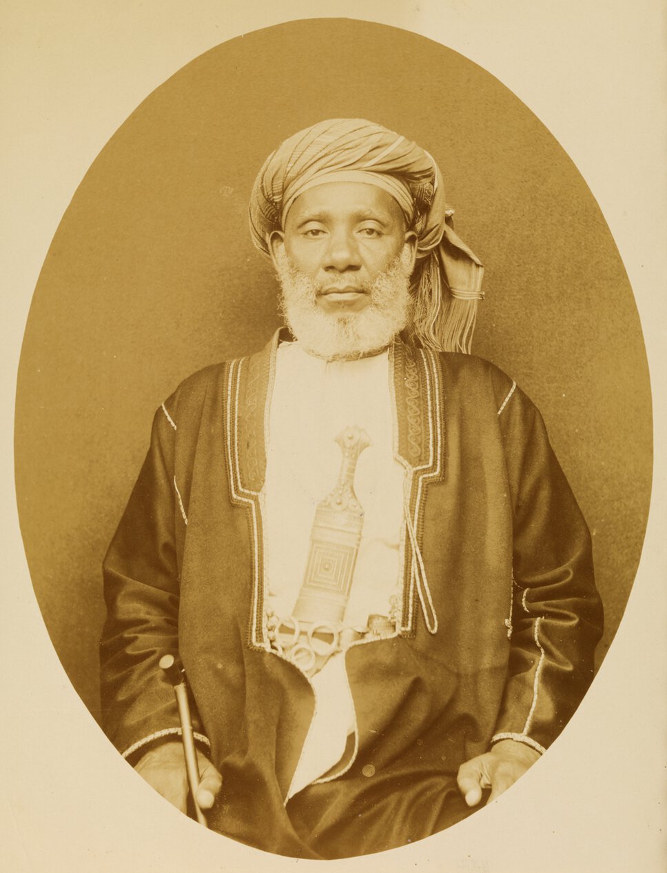 Tippu Tip in half-body portrait, standing and facing forward.