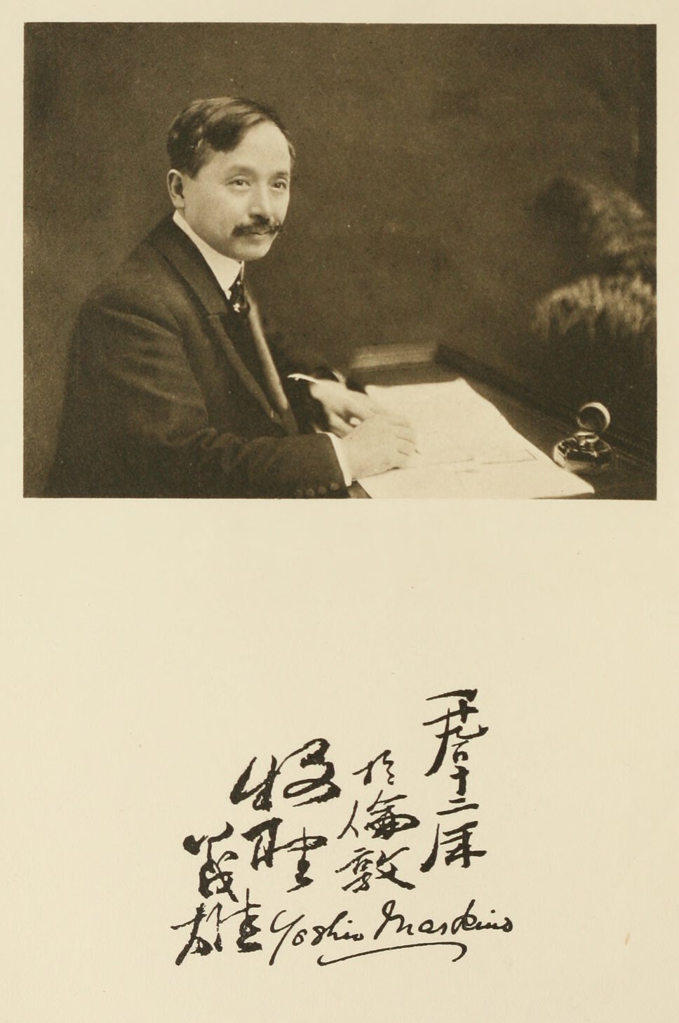Yoshio Markino seated at desk in half profile and facing forward.