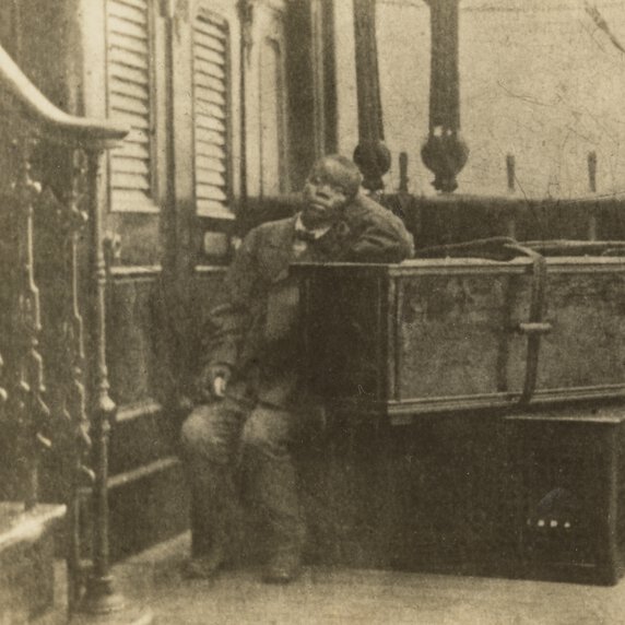 Jacob Wainwright seated on board the ship “Malwa” and leaning against David Livingstone’s coffin.