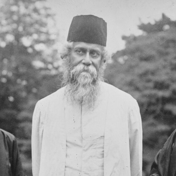 Rabindranath Tagore in three-quarter-length portrait, looking right.