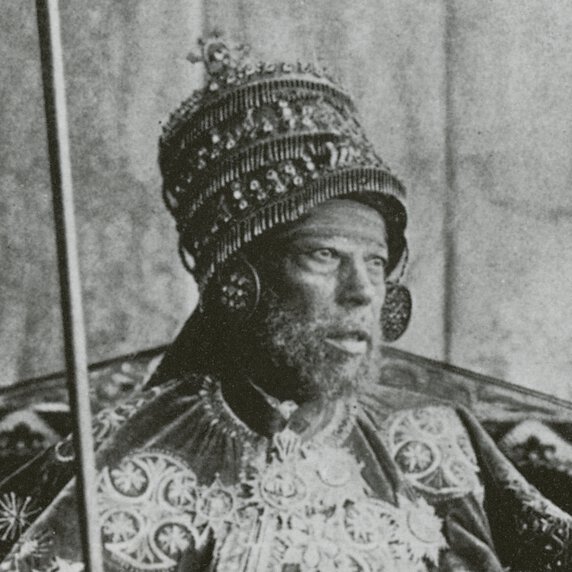 Emperor Menelik II on the throne in coronation garb.