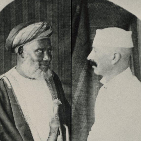 Tippu Tip and Eugene Wolf facing one another in half profile.