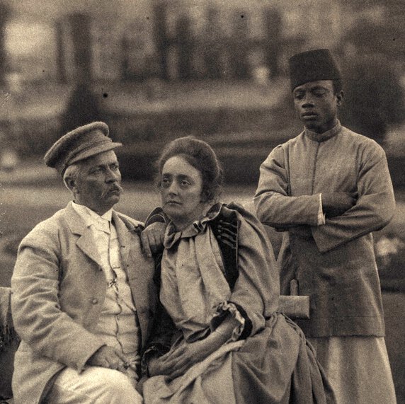 Henry Morton Stanley and Dorothy Stanley, seated, with Saleh bin Osman standing behind them.