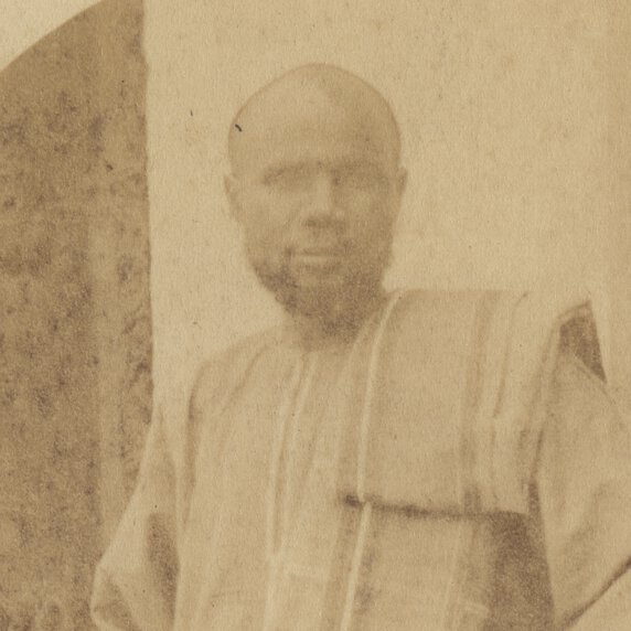 Abdullah Susi in traditional East African clothing, standing with body turned right, facing forward.