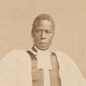 Samuel Ajayi Crowther in formal church attire, standing, facing forward with eyes right.