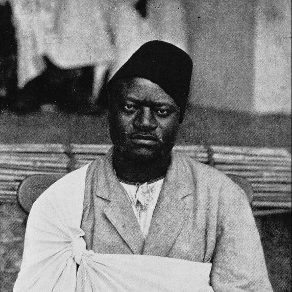 Apolo Kagwa, seated, facing forward.